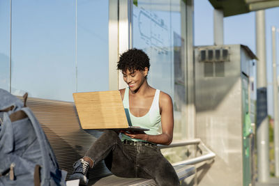 Full length of woman sitting on book