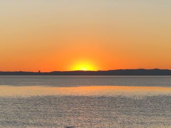 Scenic view of sea against romantic sky at sunset