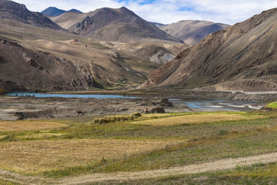 Scenic view of landscape and mountains against sky