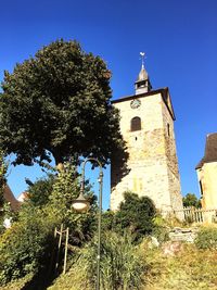 Low angle view of church against clear blue sky