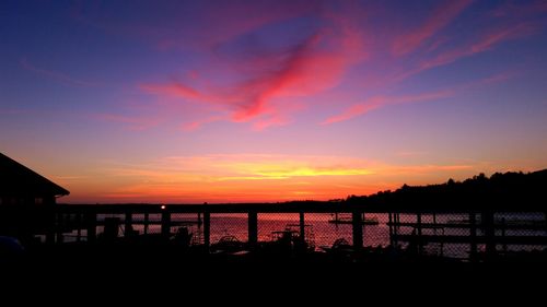 Scenic view of silhouette beach against sky at sunset