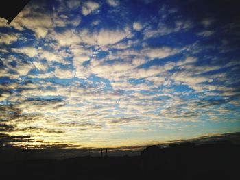 Low angle view of silhouette landscape against sky