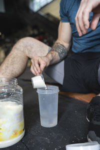 Close-up of sportsman making protien shake