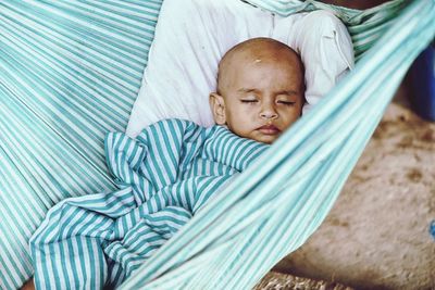 Portrait of cute boy sleeping on hammock