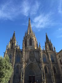 Low angle view of barcelona cathedral against sky