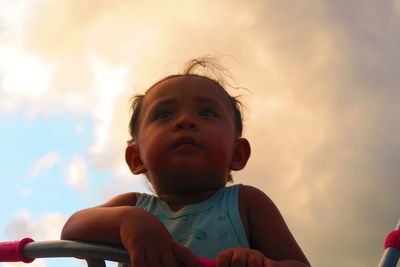 Woman with arms raised against sky