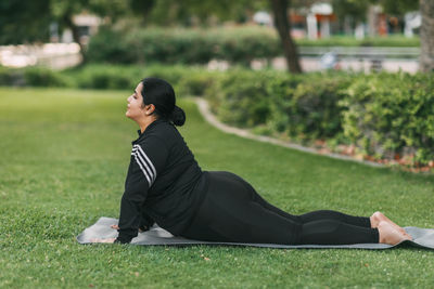 A beautiful indian girl does yoga in a summer park. healthy lifestyle. various yoga poses.