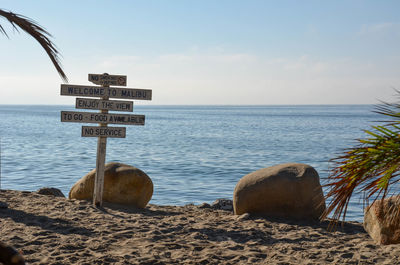 Close-up of lifeguard hut on beach against sky