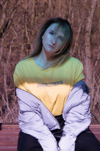 Portrait of woman sitting outdoors