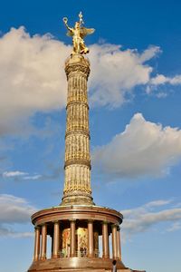 Low angle view of statue against cloudy sky