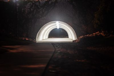 View of illuminated tunnel at night