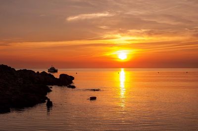 Scenic view of sea against orange sky