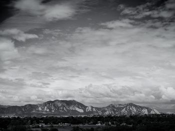 Scenic view of rocky mountains against cloudy sky