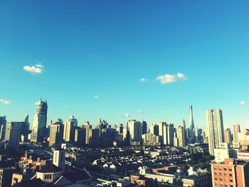 Modern buildings against cloudy sky