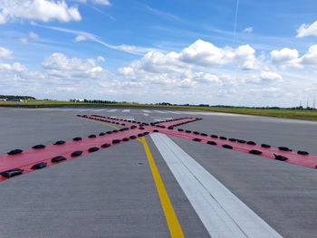 Large cross shape on airport runway against sky