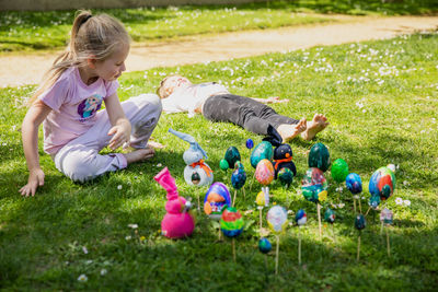 High angle view of boy playing with toys on field