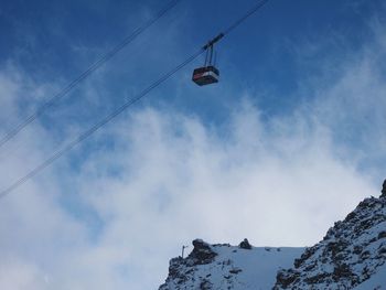 Low angle view of ski lift against sky