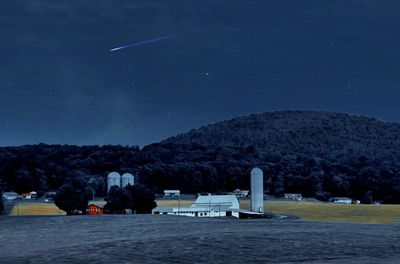 Scenic view of landscape against sky at night