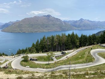 High angle view of road by lake against sky