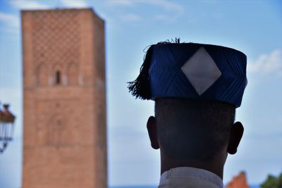 Rear view of man wearing sunglasses against sky