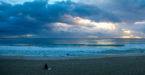 Scenic view of beach against sky during sunset