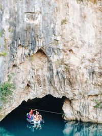 Rear view of people on rock formation
