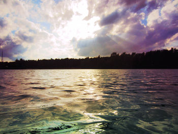 Scenic view of lake against cloudy sky