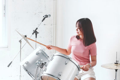 Woman looking at camera while standing at home