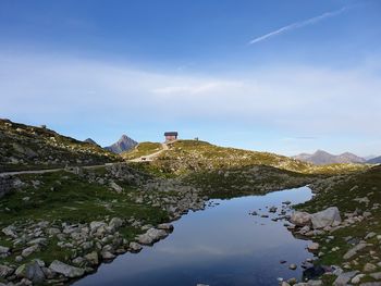 Scenic view of mountain and buildings against sky