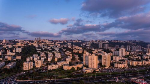 Cityscape against cloudy sky