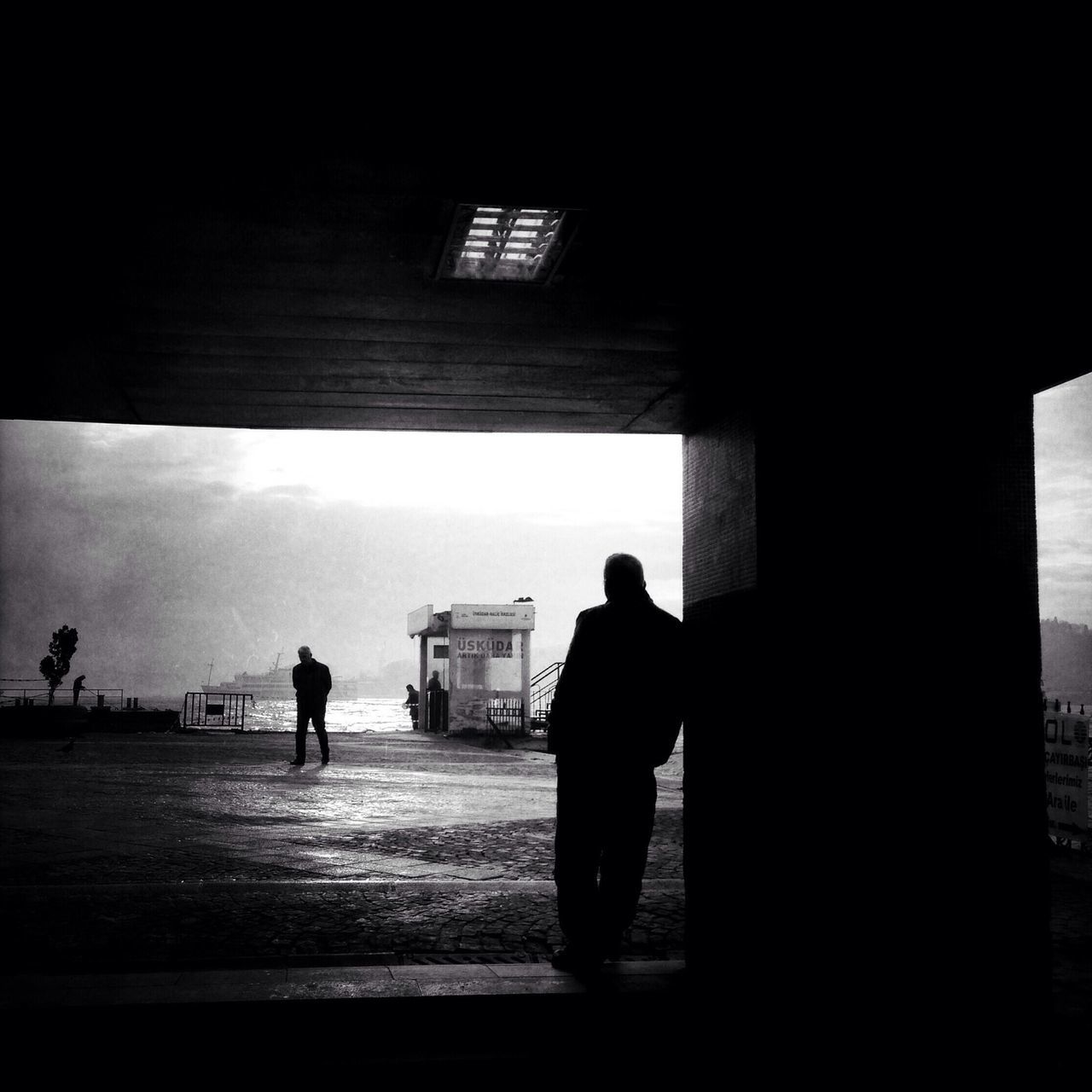 silhouette, indoors, men, rear view, architecture, lifestyles, full length, built structure, walking, person, togetherness, leisure activity, bonding, standing, sunlight, shadow, dark
