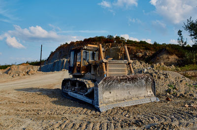 Construction site by road against sky