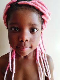 Close-up portrait of cute girl with artificial dreadlocks