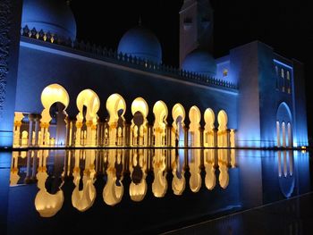 Reflection of illuminated building in water at night