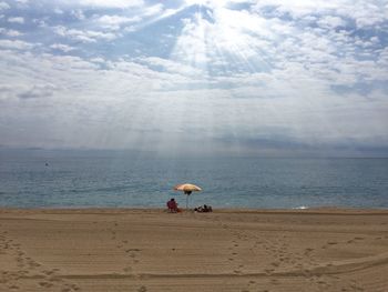 Scenic view of sea against cloudy sky