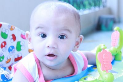 Portrait of cute baby boy sitting in high chair at home