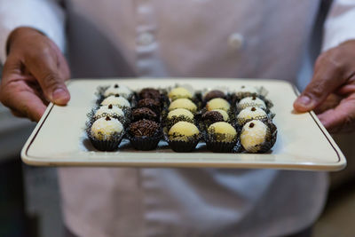 Close-up of man holding desserts