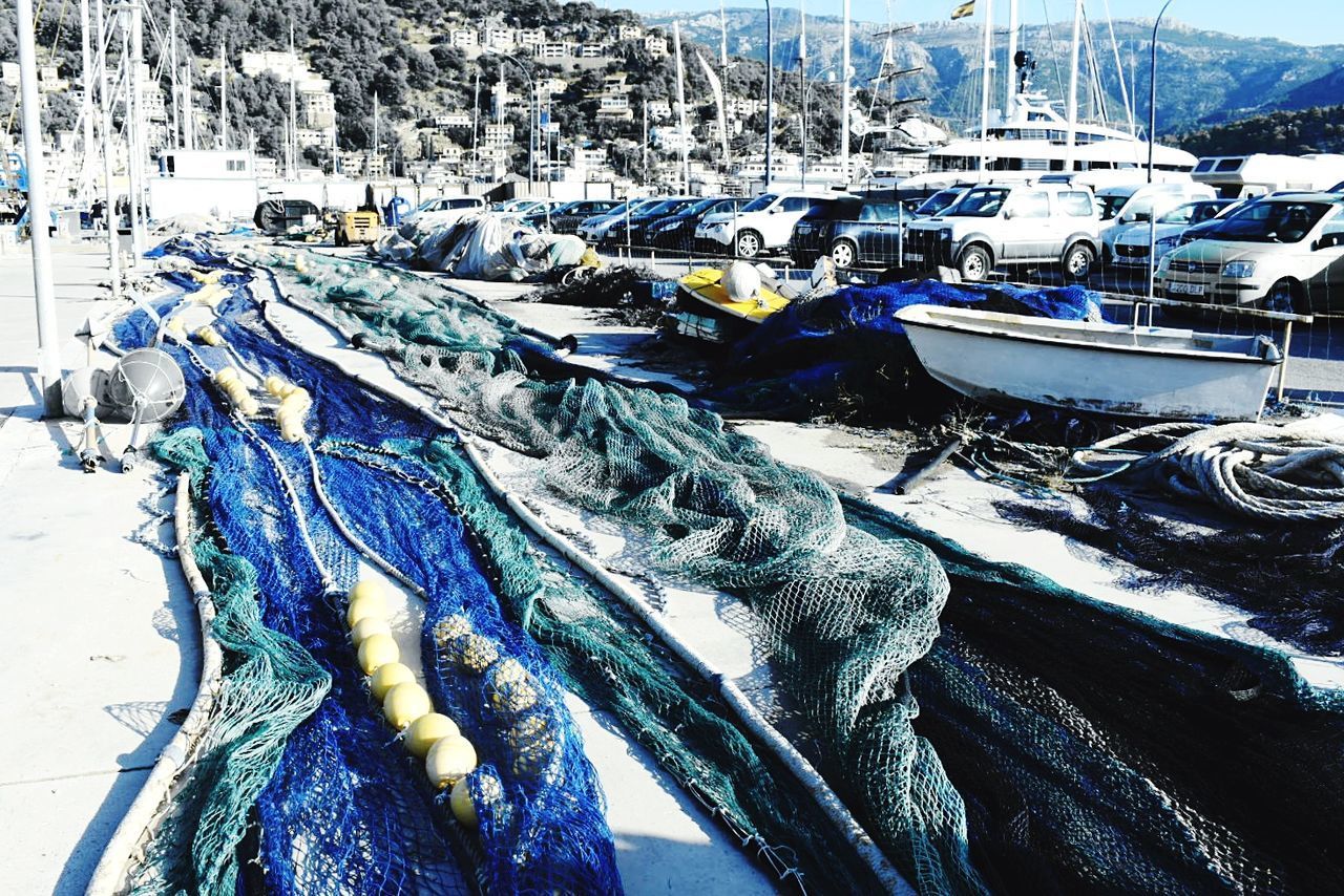 CLOSE-UP OF FISHING NET IN HARBOR