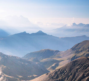 Scenic view of mountains against cloudy sky