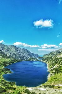 Scenic view of mountains against blue sky