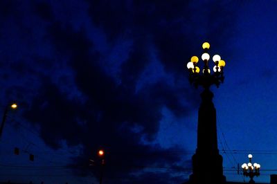 Low angle view of illuminated street light against sky at night