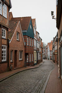 Narrow cobblestone street with old houses