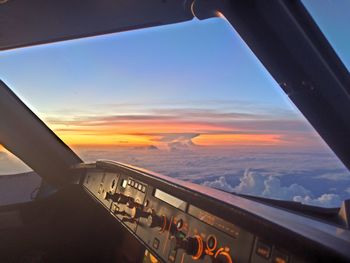 High angle view of airplane against sky during sunset