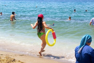 Rear view of people at beach