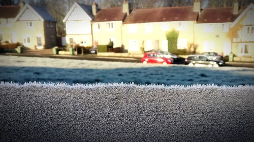 Close-up of cars on street in city