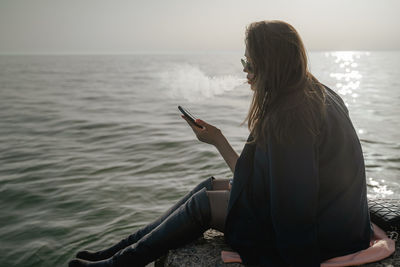 Rear view of woman looking at sea