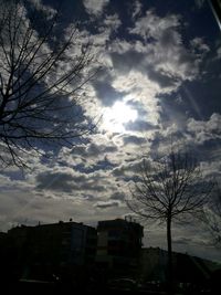 Buildings against cloudy sky