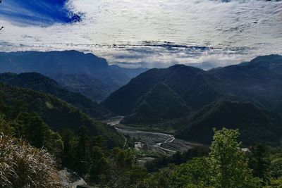 High angle view of land and mountains against sky