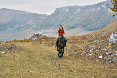 Man riding horse on field