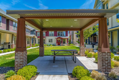 Empty benches in lawn against building